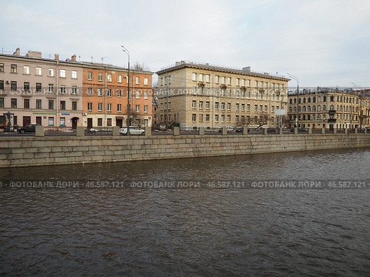 Sankt-Petersburg, Russia 01.19.25: A serene view of a river Obvodny Canal reflecting soft light of late afternoon. Historical buildings line waterfront, showcasing architectural details and city life. Редакционное фото, фотограф Юлия Петровская / Фотобанк Лори