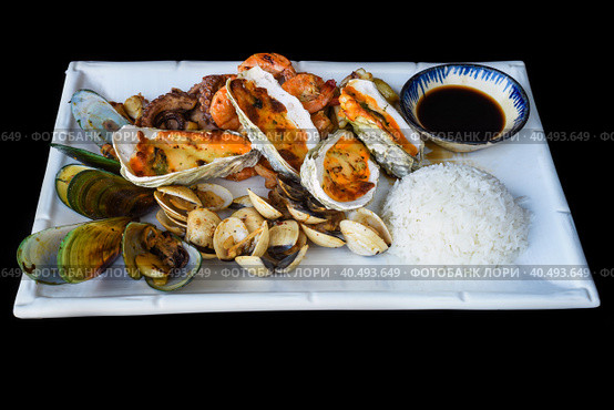 Sautéed seafood on white plate close up isolated on black background top view. Стоковое фото, фотограф Татьяна Терехина / Фотобанк Лори