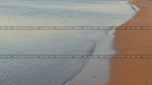 Sea waves and sand beach at sunrise, 4k. Стоковое видео, видеограф Михаил Коханчиков / Фотобанк Лори