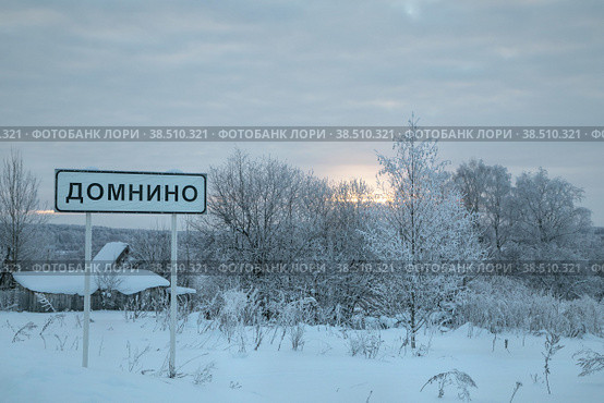 Село Домнино, Сусанинский район Костромской области. Зимний пейзаж, морозные сумерки, закат. Указатель населенного пункта (2022 год). Стоковое фото, фотограф Наталья Николаева / Фотобанк Лори