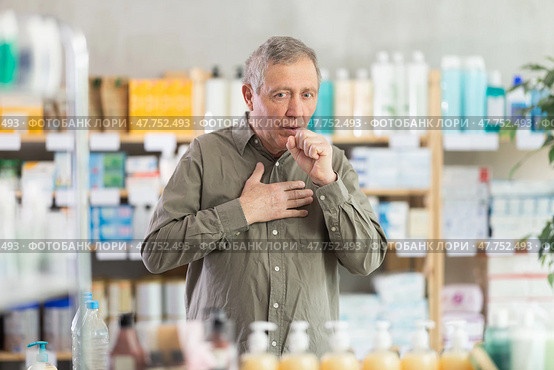 Senior man visits pharmacy and suffers from cough. Стоковое фото, фотограф Яков Филимонов / Фотобанк Лори