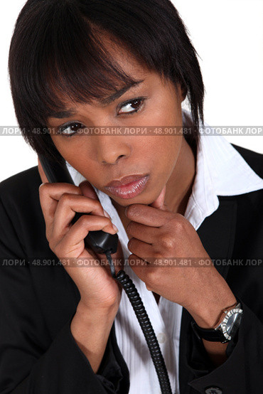 Serious businesswoman with a phone. Стоковое фото, агентство Ingram Publishing / Фотобанк Лори