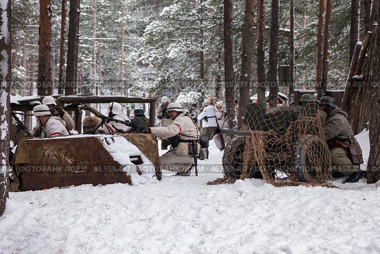 Sestroretsk, Russia - February 19, 2023: Amidst a serene winter backdrop, soldiers in historical attire engage in strategic maneuvers, preparing for battle against the chilling elements of the season. Редакционное фото, фотограф Aleksandr Golubev / Фотобанк Лори