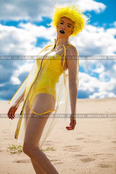 Sexy beautiful woman in a bright yellow wig and transparent raincoat. Стоковое фото, фотограф Андрей Аркуша / Фотобанк Лори