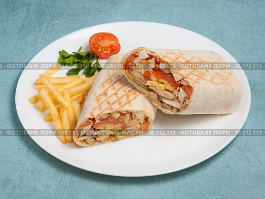 shawarma with chicken and vegetables and french fries on a blue background. Стоковое фото, фотограф Дмитрий Ульянов / Фотобанк Лори