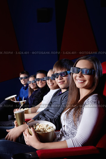Шестеро молодых людей в 3D-очках сидит в кинозале с попкорном в руках. Стоковое фото, фотограф Raev Denis / Фотобанк Лори