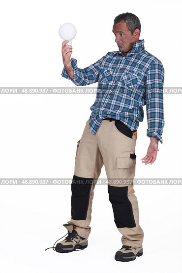 Shocked man with a lightbulb. Стоковое фото, агентство Ingram Publishing / Фотобанк Лори
