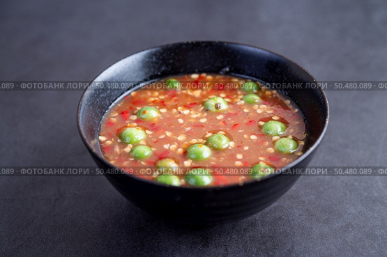 Shrimp-paste sauce in a black bowl on floor cement. Selective focus. Стоковое фото, агентство Ingram Publishing / Фотобанк Лори