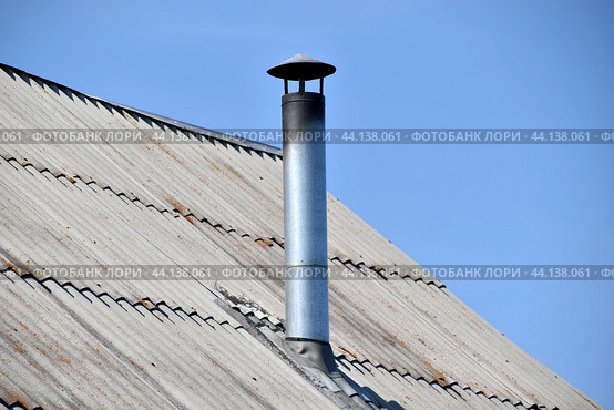 Silver stove pipe in the house against the blue sky. Стоковое фото, фотограф Valeriy Lushchikov / Фотобанк Лори