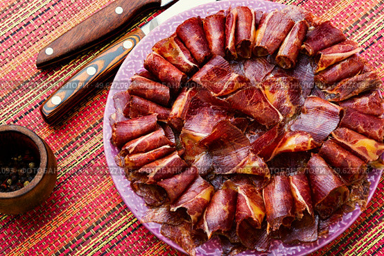 Sliced basturma or meat jerky.Beef jerky,dried beef on plate.Armenian food. Beef cured and spice,basturma. Стоковое фото, агентство Ingram Publishing / Фотобанк Лори
