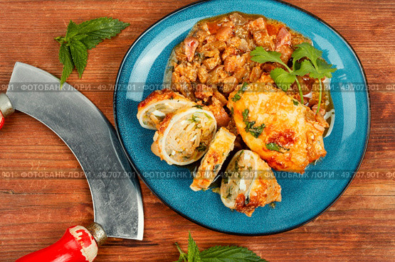 Sliced calamari or squid stuffed with rice and herbs. Bbq calamary.. Baked squid stuffed with rice. Стоковое фото, агентство Ingram Publishing / Фотобанк Лори