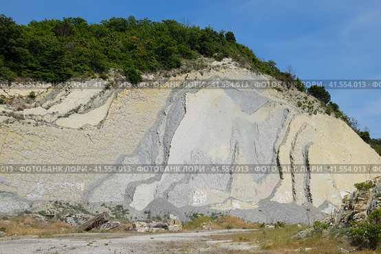 slope of the mountain with layers of sedimentary rocks. Vertically located sedimentary rocks on collapsing hillside. Стоковое фото, фотограф Леонид Еремейчук / Фотобанк Лори