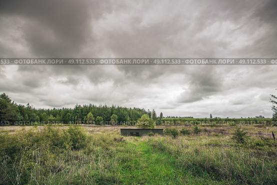 Small bunker in a military terrain in cloudy weather. Стоковое фото, агентство Ingram Publishing / Фотобанк Лори