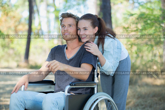 smiling disabled man looking and his girlfriend. Стоковое фото, агентство Ingram Publishing / Фотобанк Лори