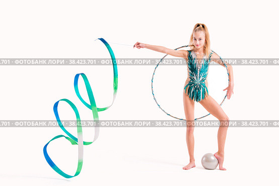 Smiling girl professional gymnast in an emerald swimsuit poses with ribbon, hoop and ball isolated on white background. Стоковое фото, фотограф Мария Мороз / Фотобанк Лори
