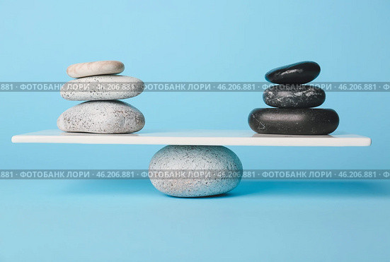 Spa stones on teeterboard against color background. Concept of balance. Стоковое фото, фотограф Pixel_shot / Фотобанк Лори