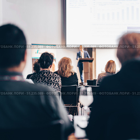 Speaker giving a talk in conference hall at business event. Rear view of unrecognizable people in audience at the conference hall. Business and entrepreneurship concept. Стоковое фото, фотограф Matej Kastelic / Фотобанк Лори