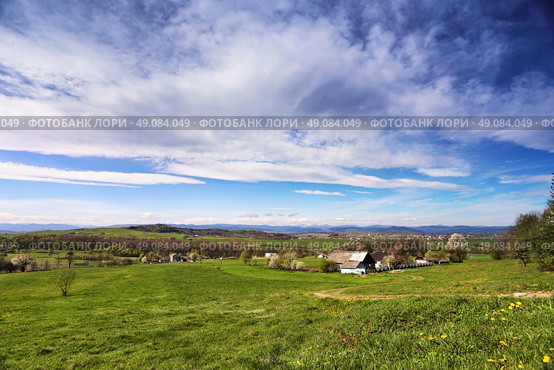 Spring green hills blooming. Valley behind the foothills in Ukraine. Стоковое фото, агентство Ingram Publishing / Фотобанк Лори