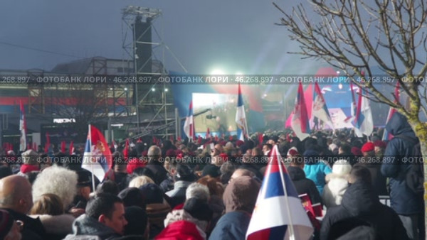 Sremska Mitrovica, Serbia 15.02.2025: Supporters of Aleksandar Vucic, Serbian statesman, politician, President of the Republic of Serbia. Supporters gathered at rally waving flags and chanting slogans (2017 год). Редакционное видео, видеограф Юлия Петровская / Фотобанк Лори