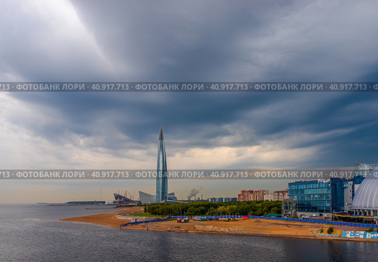 St. Petersburg, Russia - September 9, 2019. View of a skyscraper by the sea. Great skyscraper on a background of cloudy sky. Skyscraper Lakhta Center in St Petersburg is the tallest building in Europe. Редакционное фото, фотограф Андрей Степанов / Фотобанк Лори