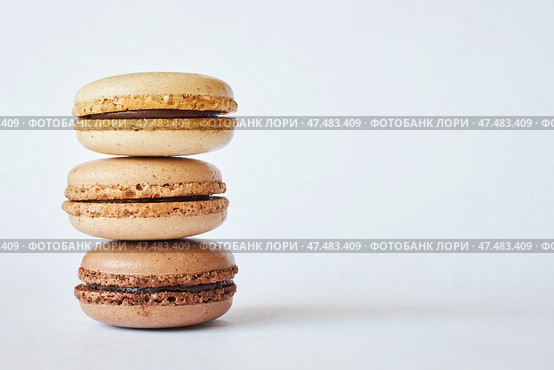 Stack of three brown French Macarons, cakes with coffee and creme brulee flavor. Стоковое фото, фотограф Екатерина Якименко / Фотобанк Лори