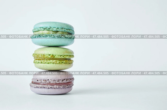 Stack of three colorful French Macarons, macaroons cakes with different flavors. Стоковое фото, фотограф Екатерина Якименко / Фотобанк Лори