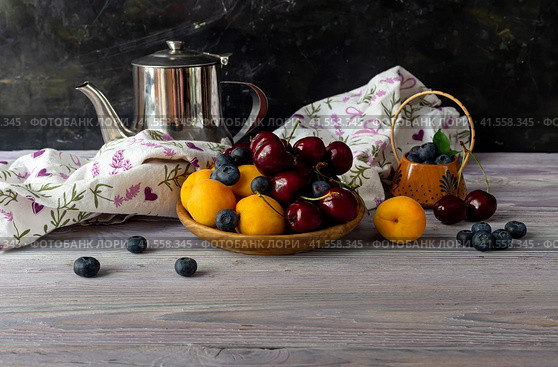 Still life with apricots, cherries and blueberries on a wooden table. Стоковое фото, фотограф Татьяна Ляпи / Фотобанк Лори