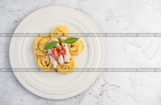 Stir-fried spaghetti and pork, beautifully arranged in a white plate. Стоковое фото, агентство Ingram Publishing / Фотобанк Лори
