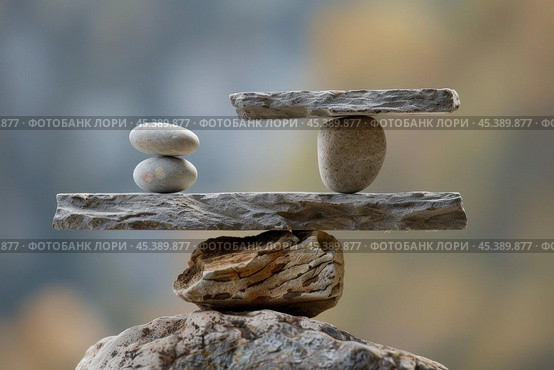 Stone balancing showing concept of justice and law on blurred background. Стоковое AI-изображение, AI-художник Иван Рябоконь / Фотобанк Лори