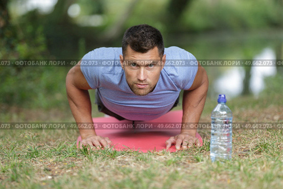 strapping young lad doing pushups in park. Стоковое фото, агентство Ingram Publishing / Фотобанк Лори