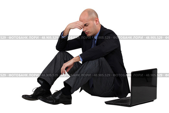 Stressed out businessman with his laptop. Стоковое фото, агентство Ingram Publishing / Фотобанк Лори