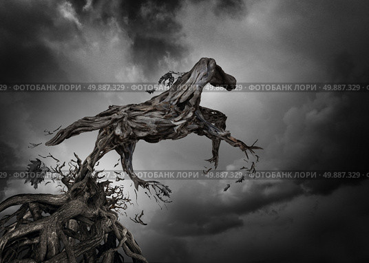 Success and potential symbol as a surreal tree horse with roots of trees shaped as a pure breed stallion breaking free from constraints to break free and move forward as a motivation for independent spirit of freedom and power. Стоковое фото, агентство Ingram Publishing / Фотобанк Лори