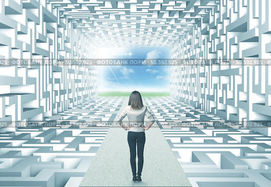 Successful businesswoman in front of a complicated labyrinth. Стоковое фото, агентство Ingram Publishing / Фотобанк Лори