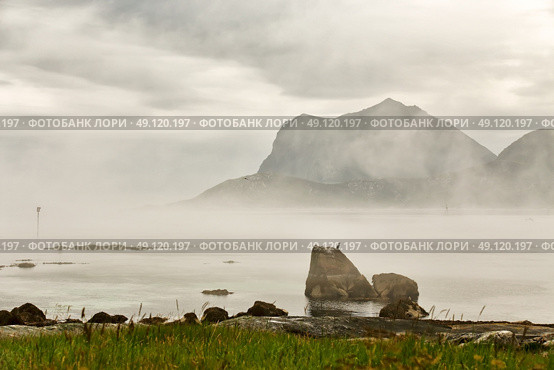 Summer cloudy Lofoten islands. Norway misty sea and fjords. Nordic rain. Стоковое фото, агентство Ingram Publishing / Фотобанк Лори