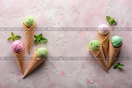 Sweet dessert. Ice cream cones with different flavors on a concrete pink background. World Ice Cream Day. Стоковое AI-изображение, AI-художник Photojuli / Фотобанк Лори