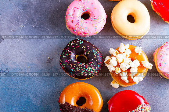 sweet doughnuts on gray stone background. sweet doughnuts top view border on gray stone background with copy space. Стоковое фото, агентство Ingram Publishing / Фотобанк Лори