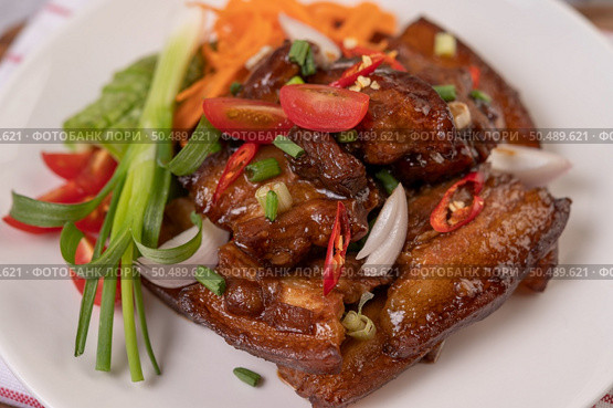 Sweet pork in a white plate with chopped scallions, chili, lime, gourd, tomato and garlic. Стоковое фото, агентство Ingram Publishing / Фотобанк Лори