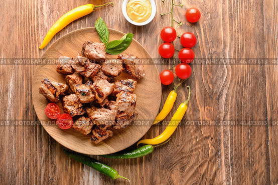 Тарелка с вкусным шашлыком и овощами на деревянном столе. Стоковое фото, фотограф Pixel_shot / Фотобанк Лори