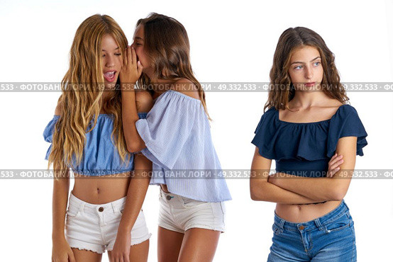 Teen best friends bullying a girl sad apart out of the game on white background. Стоковое фото, агентство Ingram Publishing / Фотобанк Лори