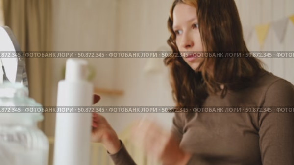 Teen Girl putting on makeup looking at mirror. Beautiful Teenager caring her face. 14 years old female applied cosmetics. Natural beauty concept. Skin care, make-up. Daily make up. Beautiful Teenage. Стоковое видео, видеограф Марина Демидюк / Фотобанк Лори
