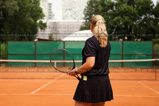 Teenage Girl Practices Her Tennis Skills on an Outdoor Court in a Vibrant Setting. Стоковое фото, фотограф Aleksandr Golubev / Фотобанк Лори