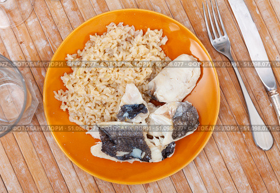 Tender meat of baked cod fillet is garnished with boiled basmati rice. Стоковое фото, фотограф Яков Филимонов / Фотобанк Лори