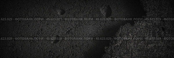 Texture of old cracked concrete wall. Rough dark gray concrete surface with spots, cracks, noise and grain. Dark wide panoramic background for design. Shaded texture with vignette. Стоковое фото, фотограф Андрей Степанов / Фотобанк Лори