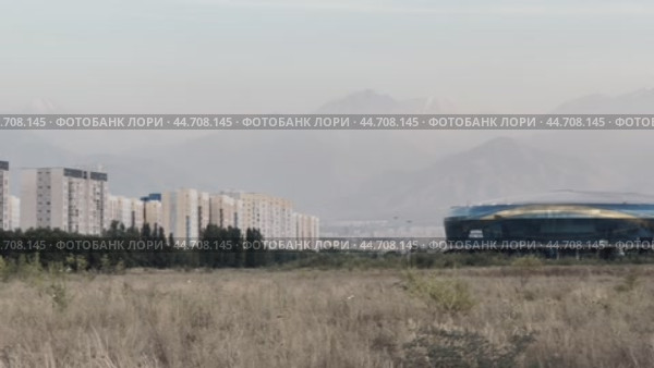 The Alma-Ata Rent sports complex and a new residential area against the backdrop of the Tien Shan spurs. Редакционное видео, видеограф Ярославский Максим / Фотобанк Лори