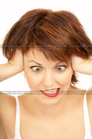 The cross-eyed woman with the tousled hair grimaces on a white background. Shock. Стоковое фото, агентство Ingram Publishing / Фотобанк Лори