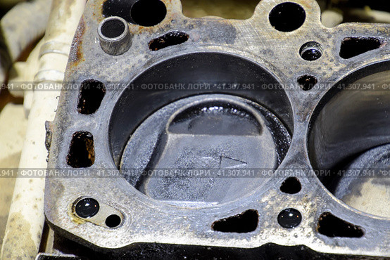 The cylinder block of the four-cylinder engine. Disassembled motor vehicle for repair. Parts in engine oil. Car engine repair in the service. Стоковое фото, фотограф Леонид Еремейчук / Фотобанк Лори