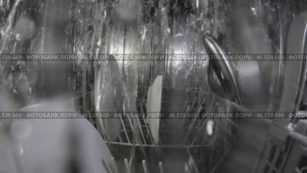 The dishwasher's function is to clean soiled dishes. The dishwasher uses a forceful stream of water to clean the dishes. A powerful jet of pressurized water removes the dirt from the dishes. Стоковое видео, видеограф Скрипачев Антон / Фотобанк Лори