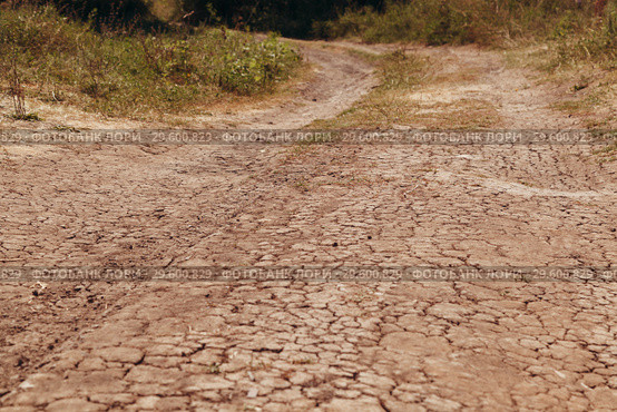 The dry road in cracks in rural areas with droughty climate. Стоковое фото, фотограф Владимир Арсентьев / Фотобанк Лори