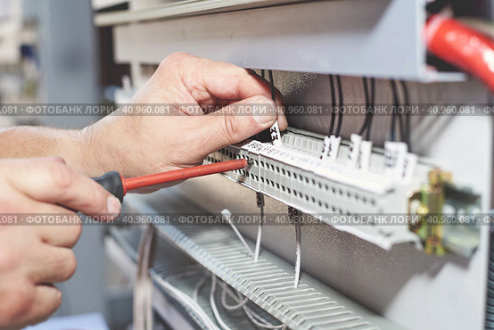 The electrician performs the installation and configuration of high-voltage equipment. Стоковое фото, фотограф Стас Пересыпкин / Фотобанк Лори
