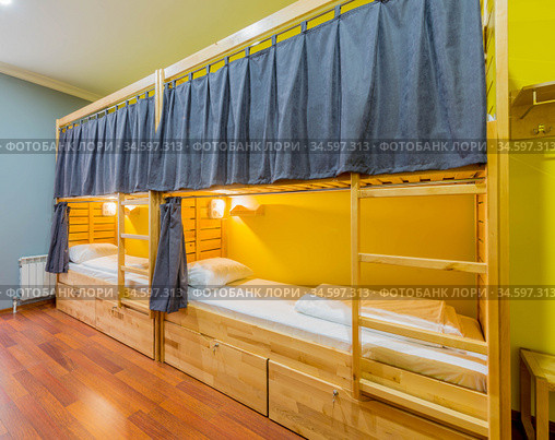 The hostel dormitory beds arranged in room. Стоковое фото, фотограф Elnur / Фотобанк Лори